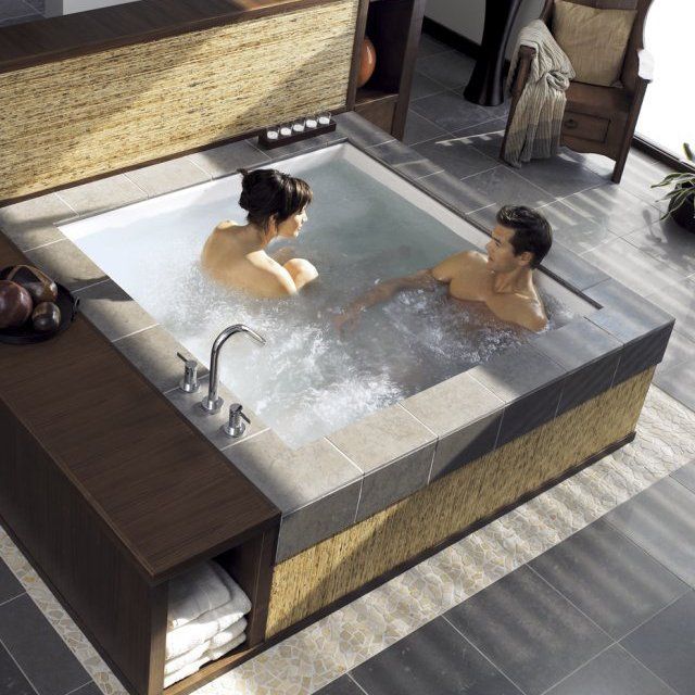 A couple in a private jacuzzi in a spa in a romantic environment